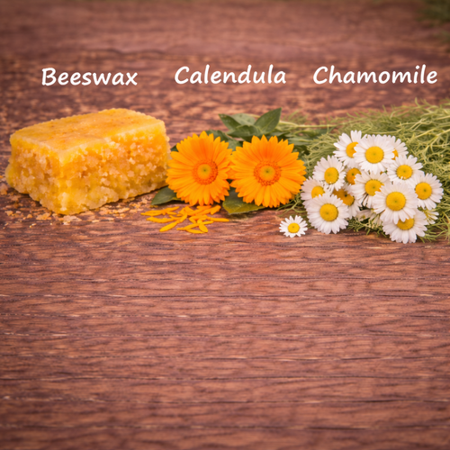 Beeswax block with calendula flowers and chamomile on a wooden background