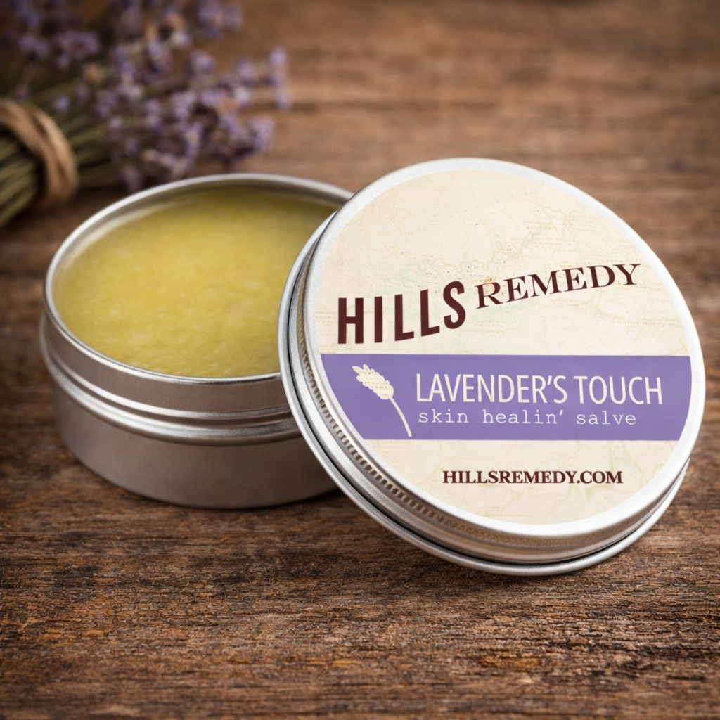Hills Remedy Lavender's Touch skin healing salve in a tin on a wooden surface with lavender flowers.