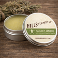 Hills Remedy salve tin with open lid on a wooden surface