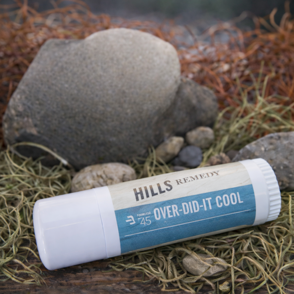 Hills Remedy Over-Did-It Cool product on grass with rocks in the background