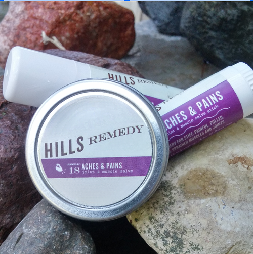 Hills Remedy jar and stick on a stone surface