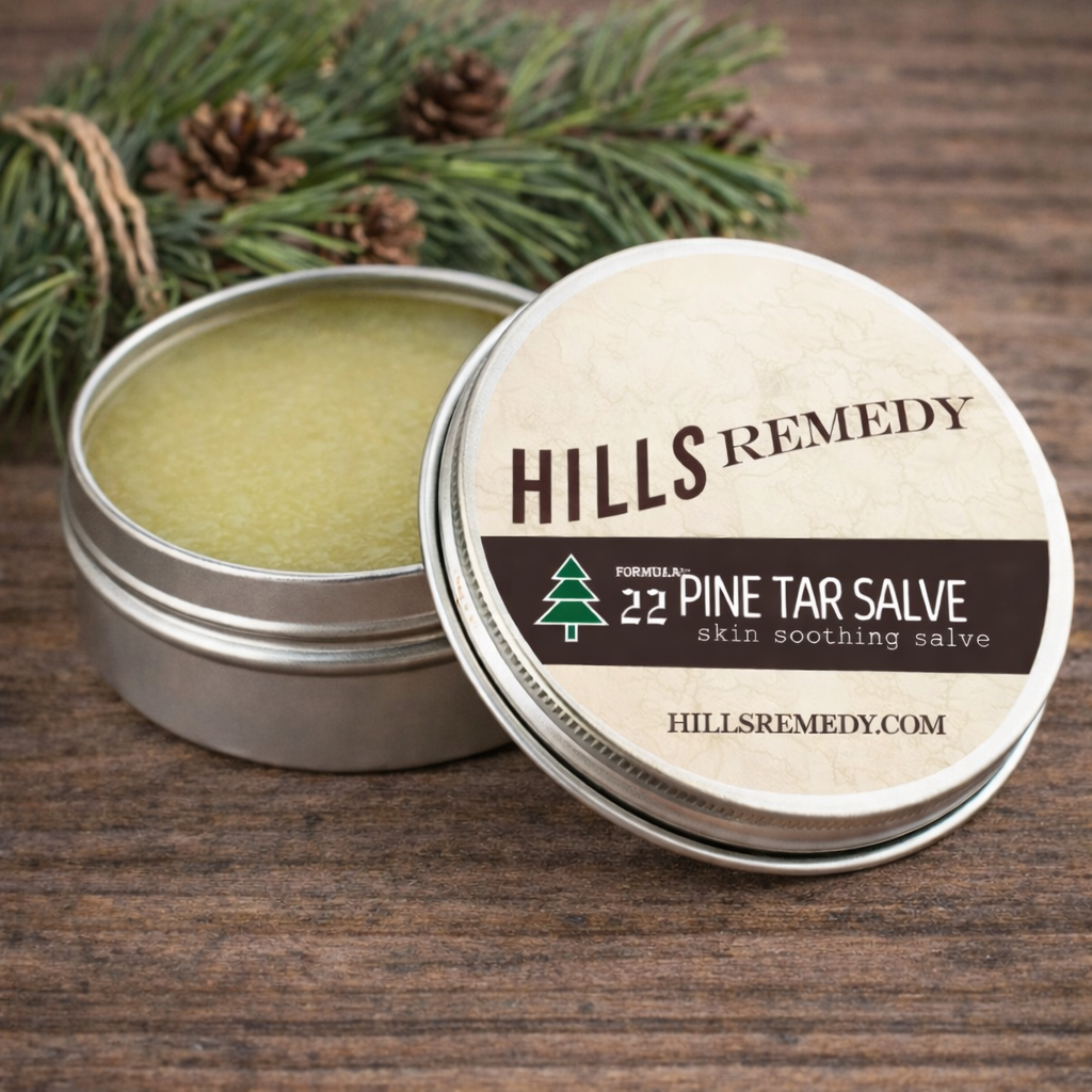 Hills Remedy pine tar salve with open lid on a wooden surface