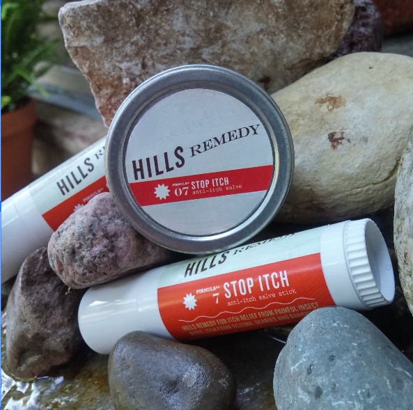 Hills Remedy stop itch product on rocks with a plant in the background